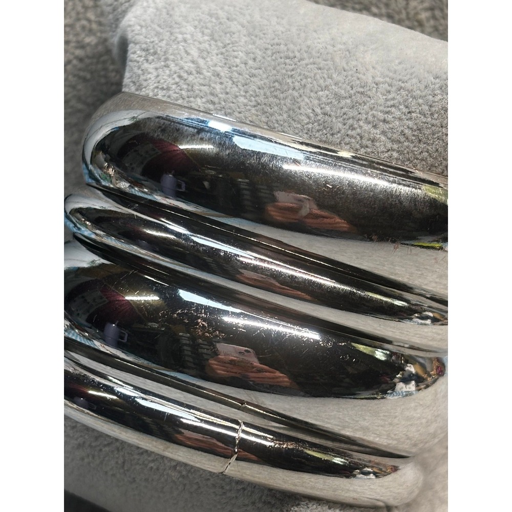 #51. Four Silver-tone Metal Bangles